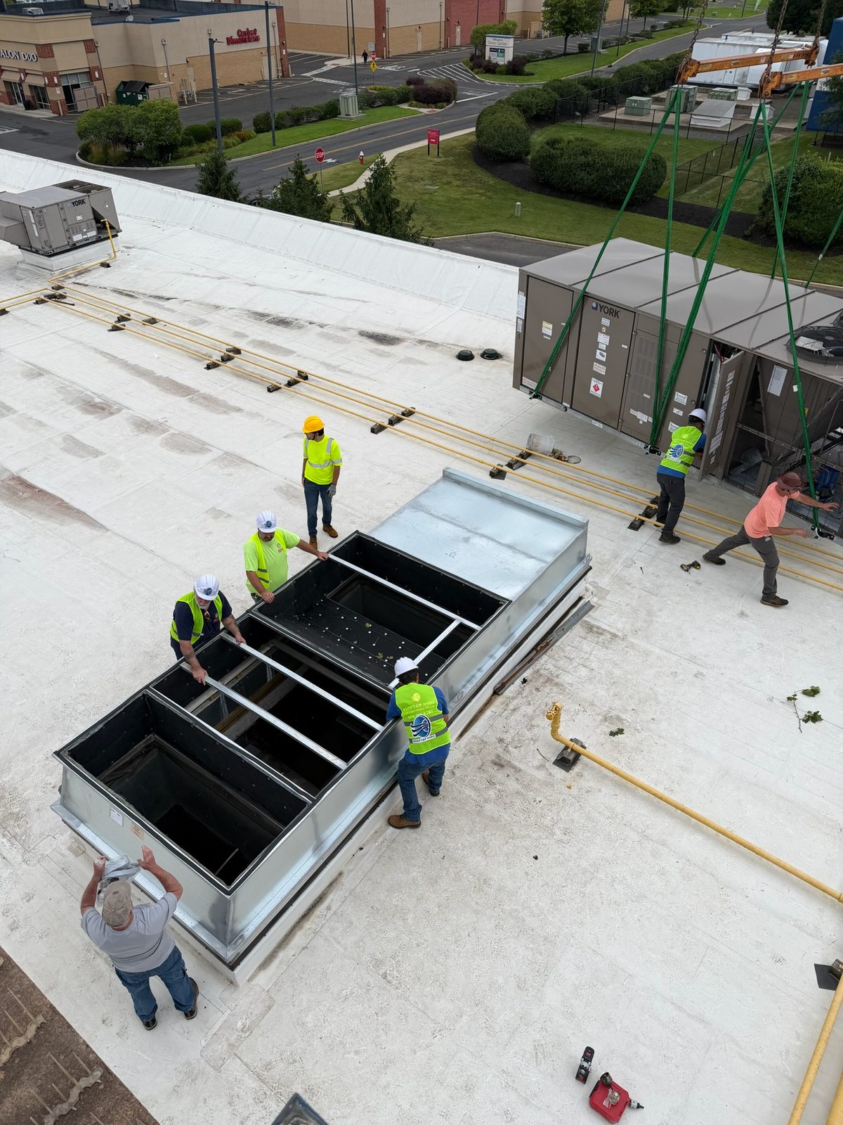 Fabricated curb adapter set on a commercial roof ahead of a rooftop unit installation