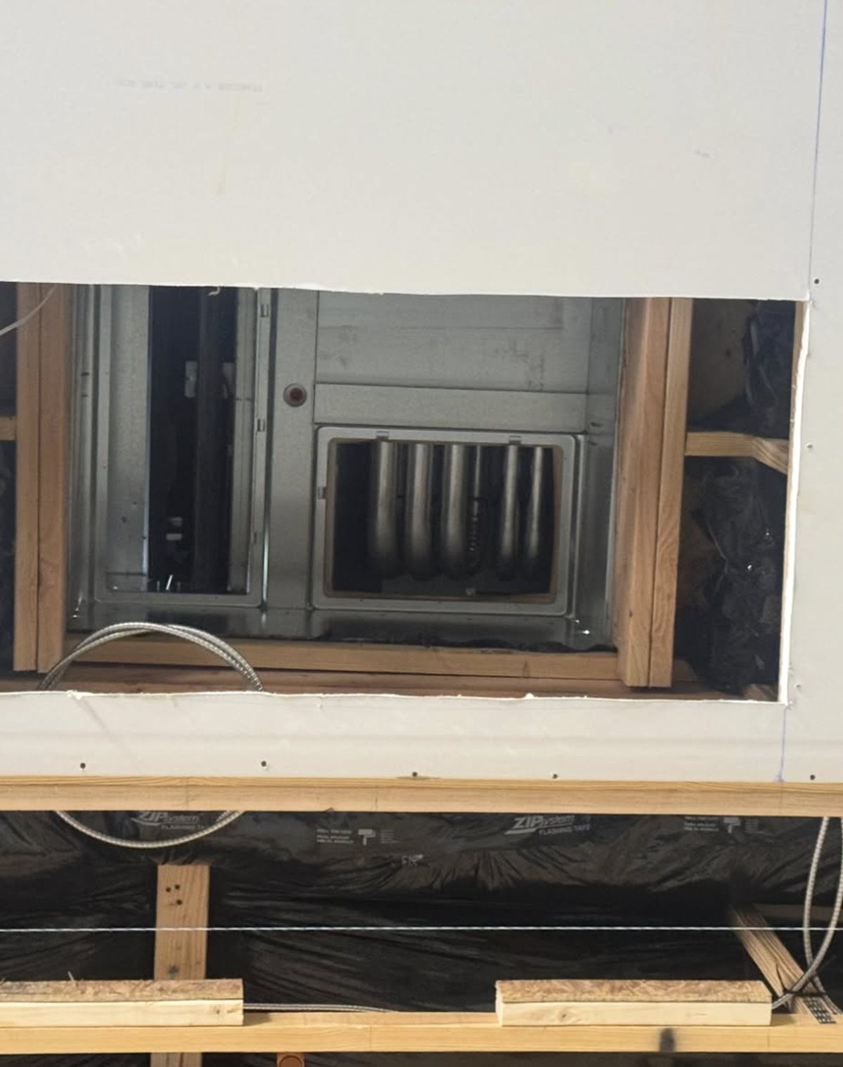 Air handler connection behind a gymnasium ceiling before closing up