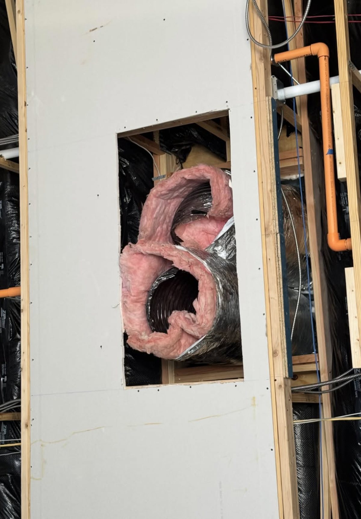 16-inch flex duct connected to concentric ductwork inside a gymnasium wall