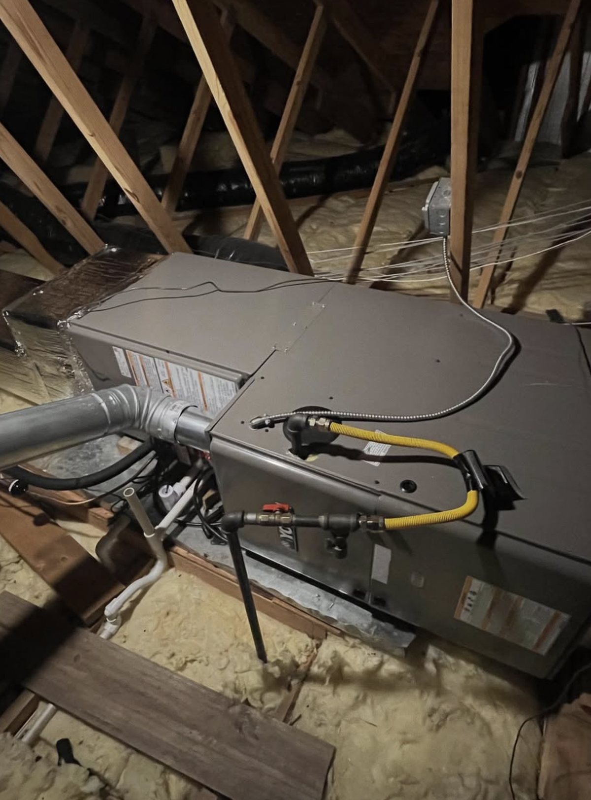 Gas connection and flue piping on a newly installed attic furnace
