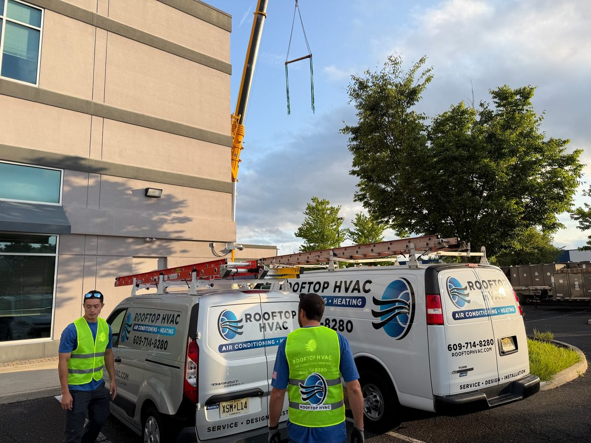 Rooftop HVAC service vans and crew on site at a commercial building in South Jersey
