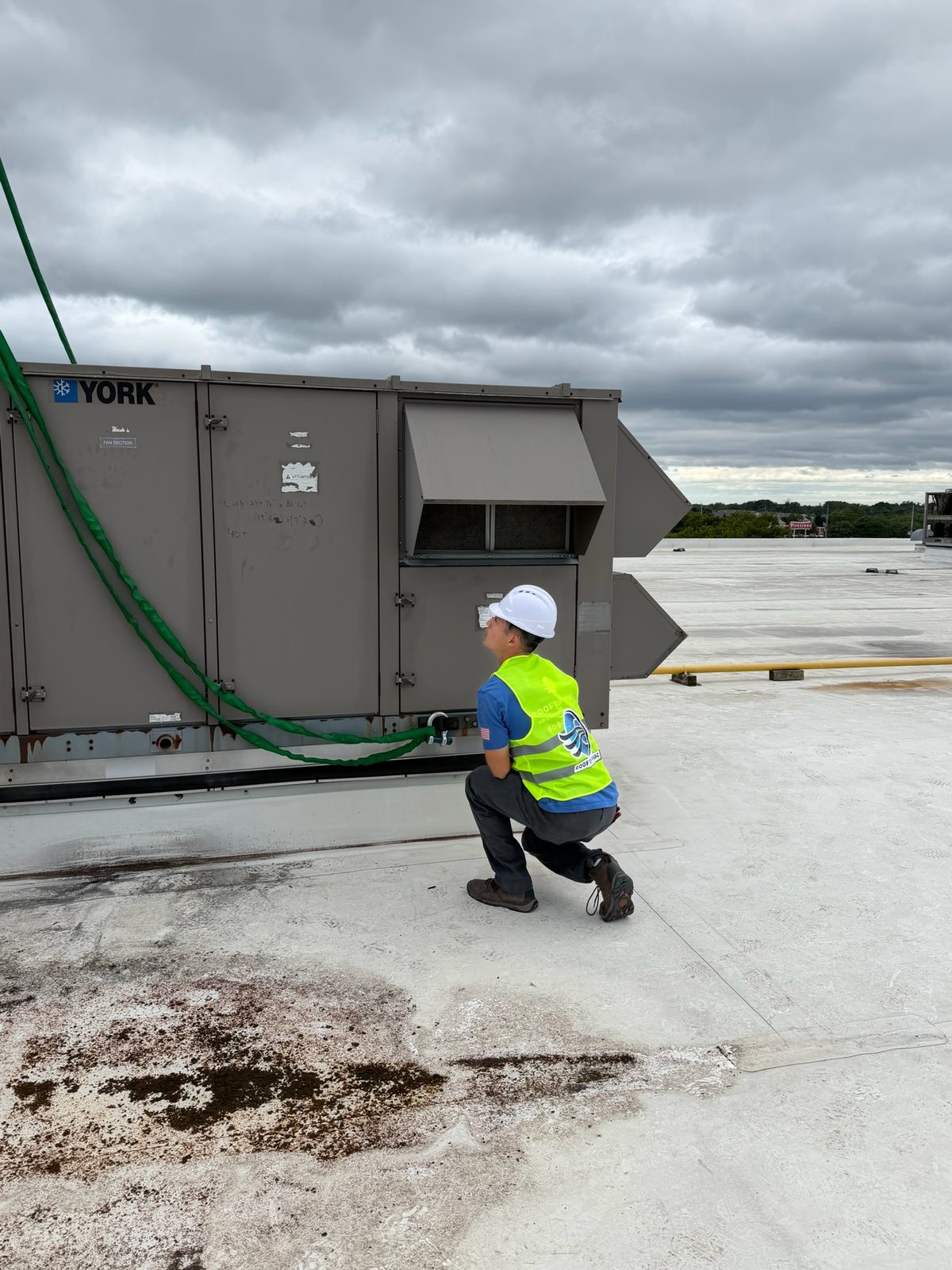 Rooftop HVAC technician servicing a York rooftop unit